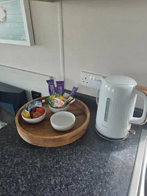 a tray of food on a counter with a coffee maker at 6 Birth Caravan Quay West Sea Views in New Quay
