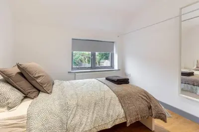 a bedroom with a bed with a large window at Zest Homes 87 Bridge Street in Leominster