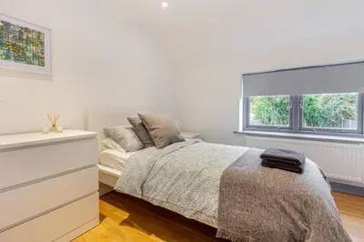 a white bedroom with a bed and a window at Zest Homes 87 Bridge Street in Leominster