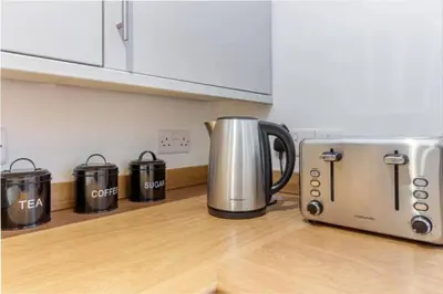a kitchen counter with a coffee pot and a toaster at Zest Homes 87 Bridge Street in Leominster