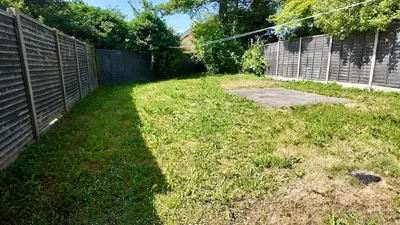 a backyard with a fence and a grass yard at Zest Homes 87a Bridge Street in Leominster