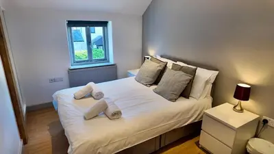 a bedroom with a large white bed with two pillows at Zest Homes 87a Bridge Street in Leominster