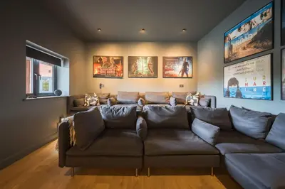 a living room with a brown leather couch at Ty Cefn by Birch Stays in Llangyniew