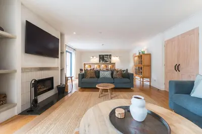 a living room with a couch and a fireplace at Ty Cefn by Birch Stays in Llangyniew