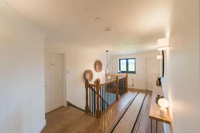 a hallway with a staircase in a house at Ty Cefn by Birch Stays in Llangyniew