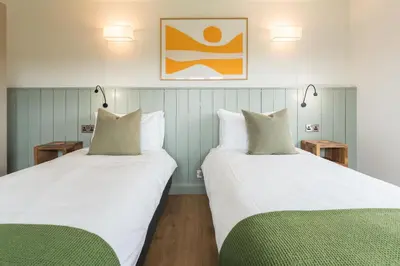 two beds sitting next to each other in a room at Ty Cefn by Birch Stays in Llangyniew