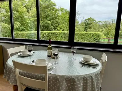 a table with a bottle of wine and two glasses at Nanternis Farm in New Quay