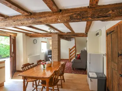 a kitchen and dining room with a wooden table and chairs at Ford Farm in Ludlow