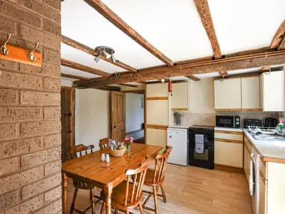 a kitchen and dining room with a wooden table and chairs at Ford Farm in Ludlow