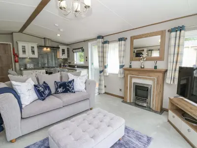 a living room with a couch and a fireplace at 34 The Beaumont in New Quay