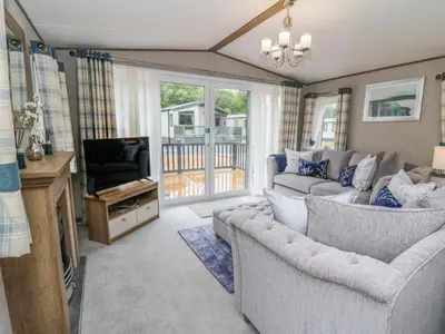 a living room with a couch and a television at 34 The Beaumont in New Quay