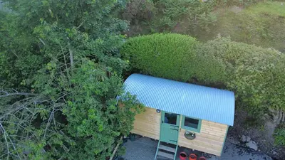 an overhead view of a tiny house with a blue roof at Myndy The Shepherd's Hut in Church Stretton
