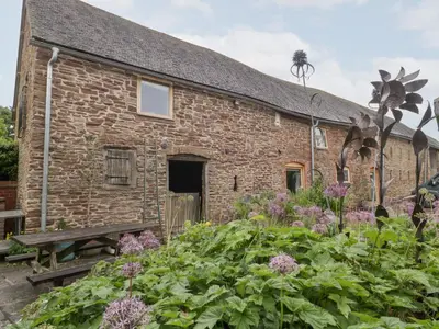 a stone house with a garden in front of it at The Art House in Leominster