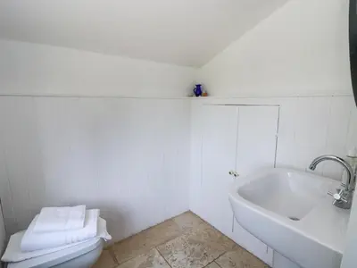 a bathroom with a sink and a tub and a toilet at The Retreat at Glanrannell Park House in Llanwrda