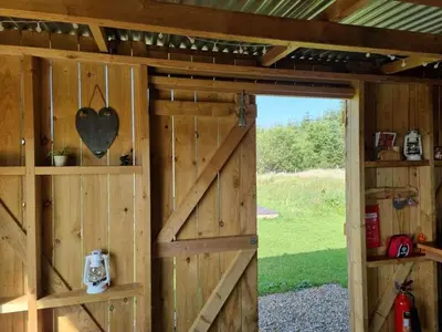 a barn door with a heart on the wall at Glamping Pod - Sleeps 2 - Pets - Parking - Wifi in Llanon