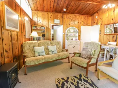 a living room with a couch and a chair at Ty Bedwen in Machynlleth