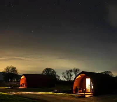 a couple of barns in a field at night at Bwthyn Bach Brefi in Tregaron