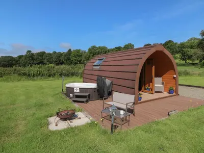 a small building with a hot tub and a deck at Ty Twt Teifi in Tregaron