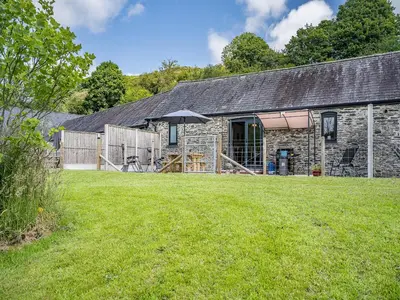 a stone barn with a yard in front of it at The Old Cowsheds 3 - Mynach - Uk49788 in Cribyn
