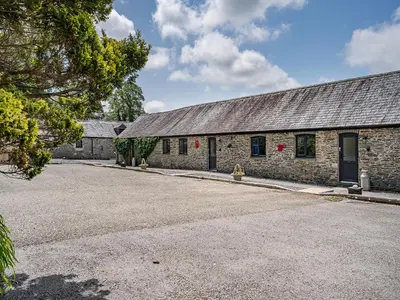 a brick building with a parking lot in front of it at The Old Cowsheds 3 - Mynach - Uk49788 in Cribyn