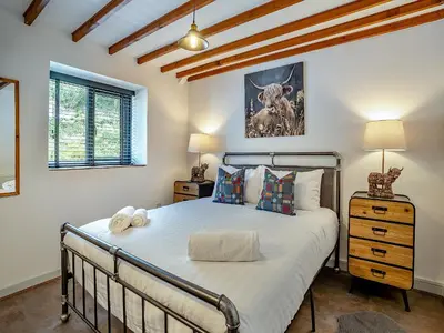 a bedroom with a bed in a room at The Old Cowsheds 3 - Mynach - Uk49788 in Cribyn