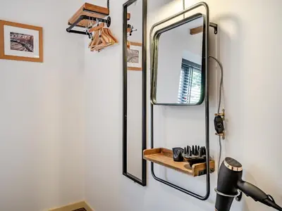 a mirror hanging on a wall with a shelf at The Old Cowsheds 1- Dairy - Uk49786 in Cribyn