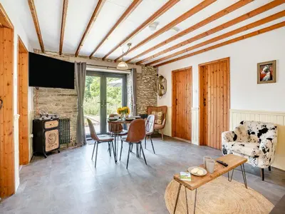 a living room with a table and chairs at The Old Cowsheds 1- Dairy - Uk49786 in Cribyn