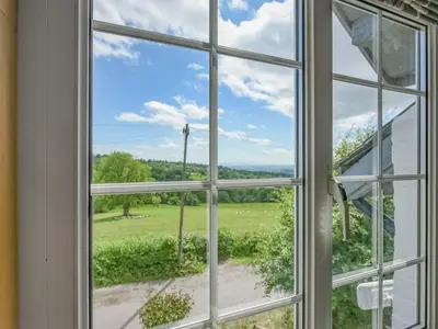 a window with a view of a field at Clee View Cottage in Ludlow