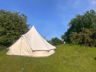a tent sitting in the grass in a field at Bell Tent - Lakeside in Oswestry