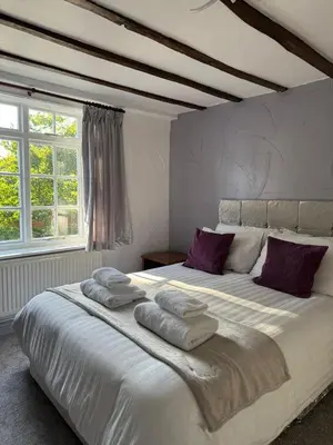 a bedroom with a large bed with towels on it at Vesna Affordable comfort in Newtown