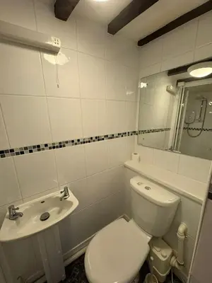 a white bathroom with a toilet and a sink at Vesna Affordable comfort in Newtown
