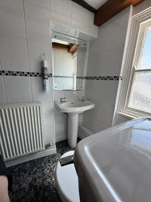 a bathroom with a sink and a tub and a mirror at Vesna Affordable comfort in Newtown