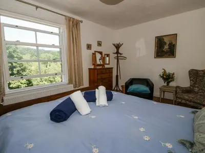 a bedroom with a blue bed with towels on it at 157 Watling Street South in Church Stretton
