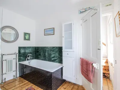 a white bathroom with a sink and a mirror at 157 Watling Street South in Church Stretton