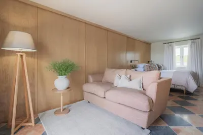 a living room with a couch and a bed at Llys y wawr Luxury Holiday Let in Aberystwyth