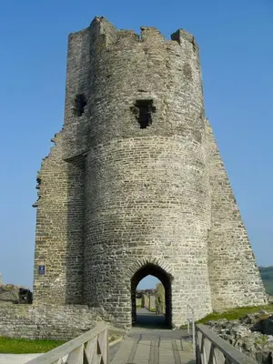 a large stone tower with an archway in a castle at Sanderling, 289 Ynyslas Beach, Borth in Borth