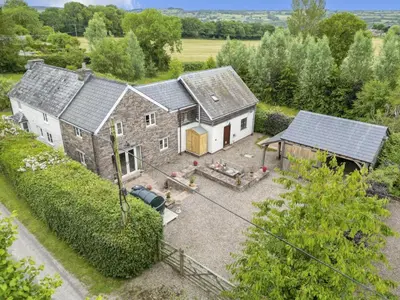 an aerial view of a house with a yard at Priory cottage in Clifford