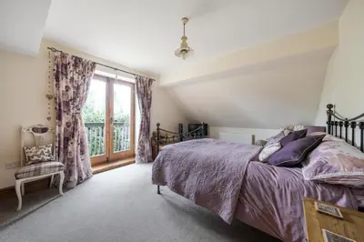 a bedroom with a bed and a window at Priory cottage in Clifford