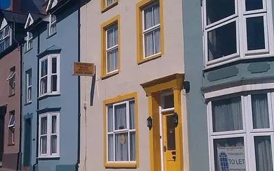 a colorful building on the side of a street at Ty Sunnymead Guesthouse in Aberystwyth