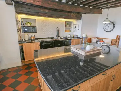 a kitchen with a stove and a counter top at Bwthyn Mawr in Harlech