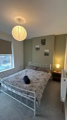 a bedroom with a bed with a blue pillow on it at Builth wells stay in Builth Wells
