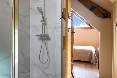 a bathroom with a shower with a glass door at Swn y Nant in Glyn-Ceiriog