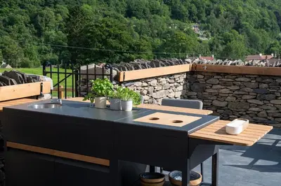 a outdoor table with a sink and a stone wall at Swn y Nant in Glyn-Ceiriog