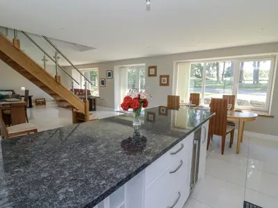 a kitchen with a counter with a vase of flowers on it at Little Penrhosgoch Barn in Llandrindod Wells