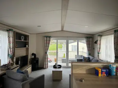 a living room with a couch and a table at 186 Barmouth Bay Holiday Park in Barmouth