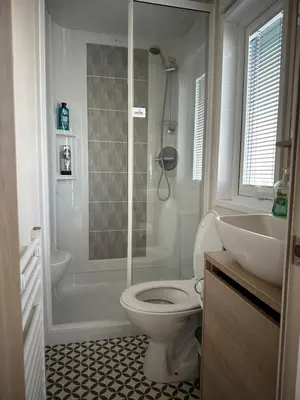 a bathroom with a shower and a toilet and a sink at 186 Barmouth Bay Holiday Park in Barmouth