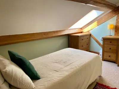 a bedroom with a bed and a skylight at Cae Madog Barn in Llanbrynmair