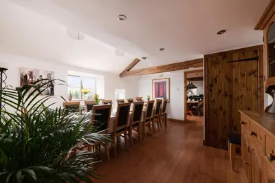 a dining room with chairs and a dining table at Cae Madog Barn in Llanbrynmair