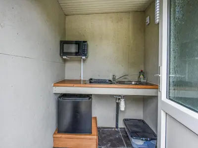 a small kitchen with a sink and a microwave at The Owl Pod - Uk50070 in Welshpool