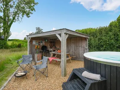 a gazebo with a table and chairs next to a pool at The Hedgehog Pod - Uk50067 in Welshpool